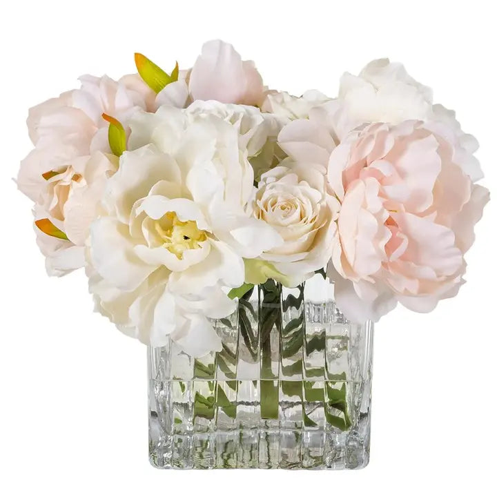Front product view of The Rosalie Peony & Rose Arrangement with blush and ivory blooms in a square clear glass vase.