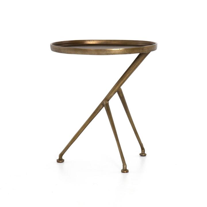 Full view of the Arlette Tripod Accent Table showing its lipped top, angular cast-aluminum frame, and raw-brass finish.
