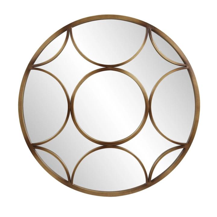 The Éliane Mirror with layered rounded metal geometry in a brushed matte-bronze finish.
