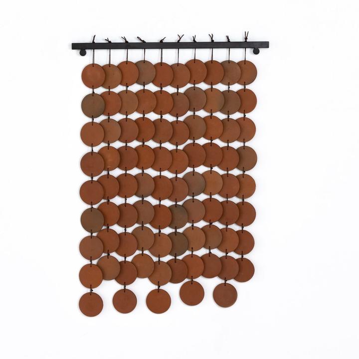 Full view of the Marlow Ceramic Wall Hanging showing the vertical field of terracotta discs suspended from a slim horizontal bar.