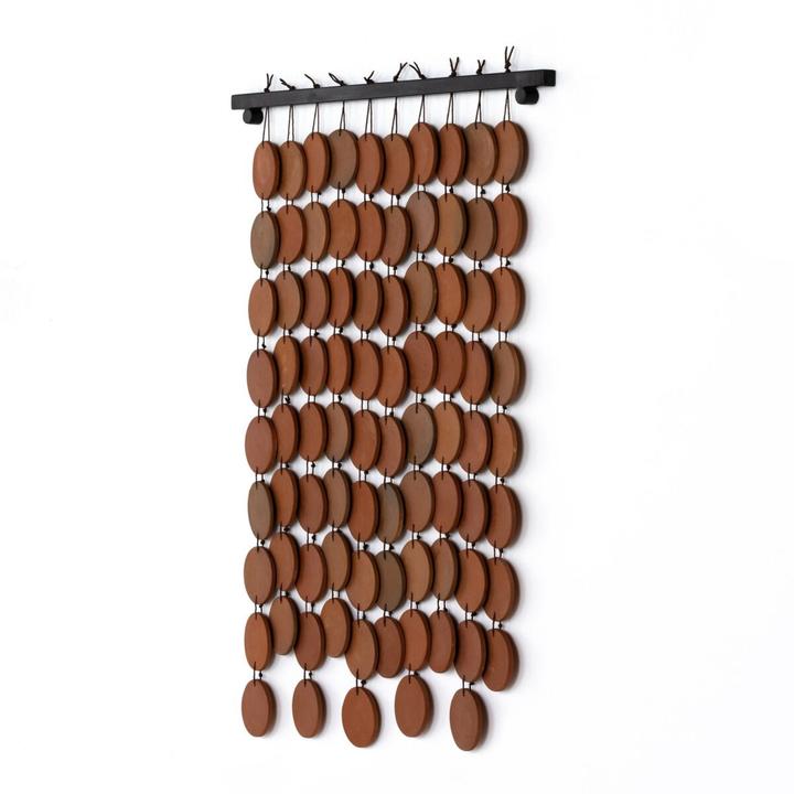 Detail view of the Marlow Ceramic Wall Hanging highlighting the rounded terracotta discs, brown cord, and layered spacing.