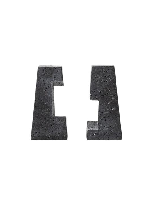 Separated pair of Converge lava-stone bookends showing the fitted notches and porous black surfaces.