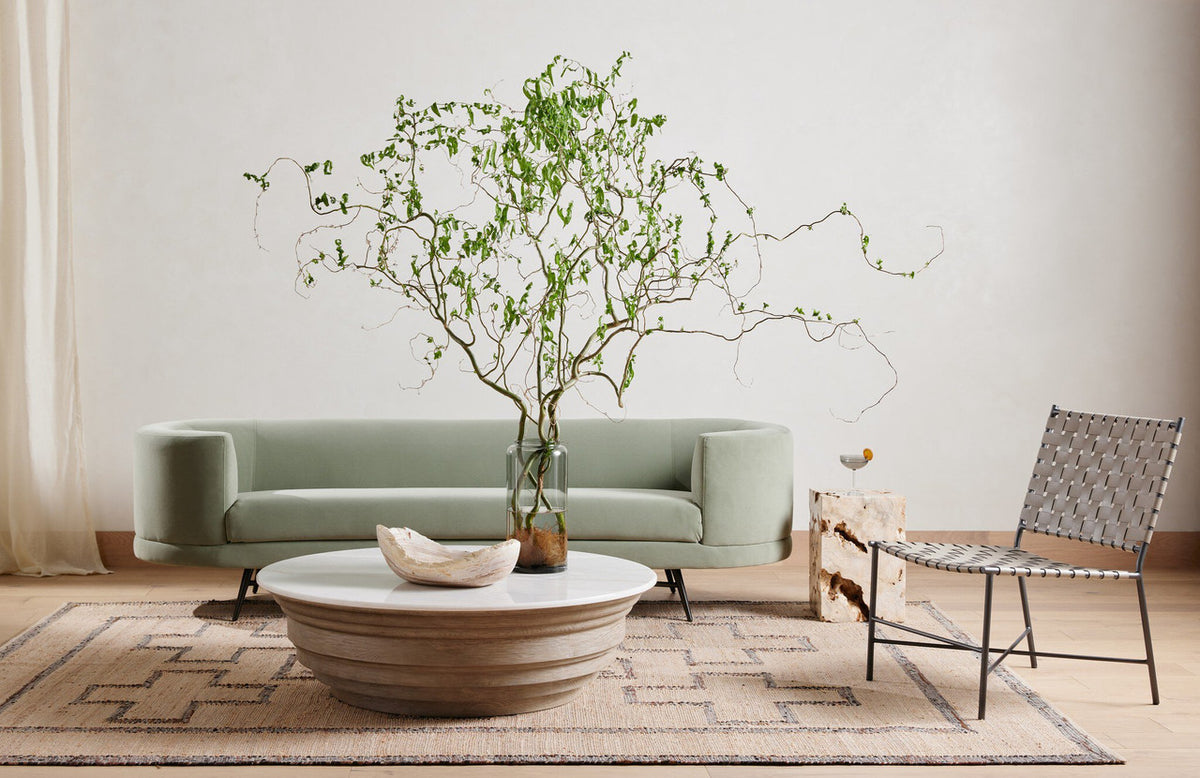 The Palu Accent Table in solid Romano Fosse travertine, showing its compact monolithic form and naturally porous stone surface.