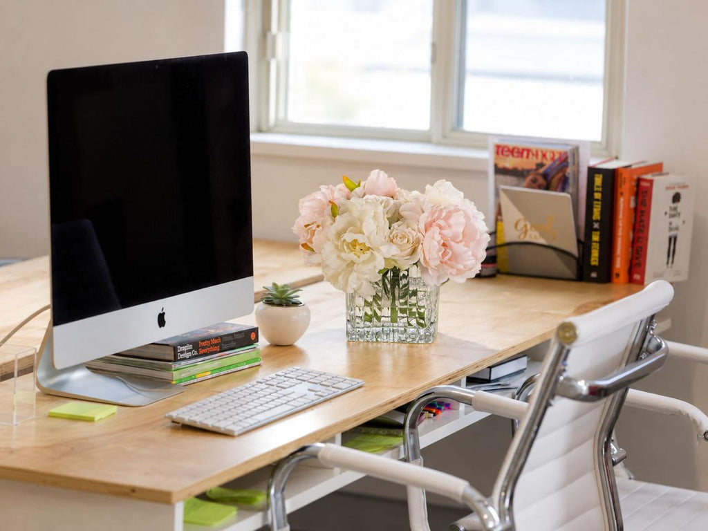 Rosalie Peony & Rose Arrangement styled on a light wood office desk beside a computer and books.