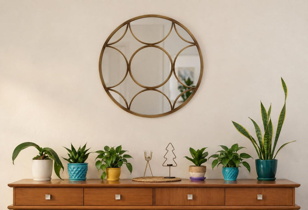 Detail view of the Éliane Mirror emphasizing the repeated rounded shapes within the bronze frame.