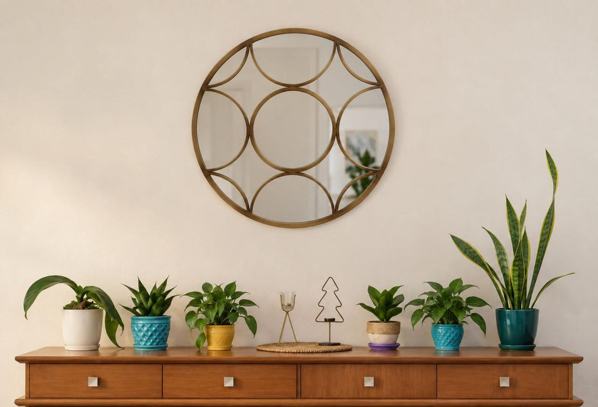 Detail view of the Éliane Mirror emphasizing the repeated rounded shapes within the bronze frame.