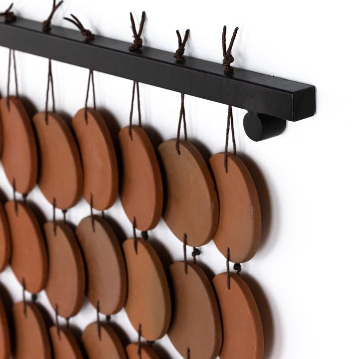 Close view of the Marlow Ceramic Wall Hanging emphasizing the warm terracotta surface and repeated circular geometry.