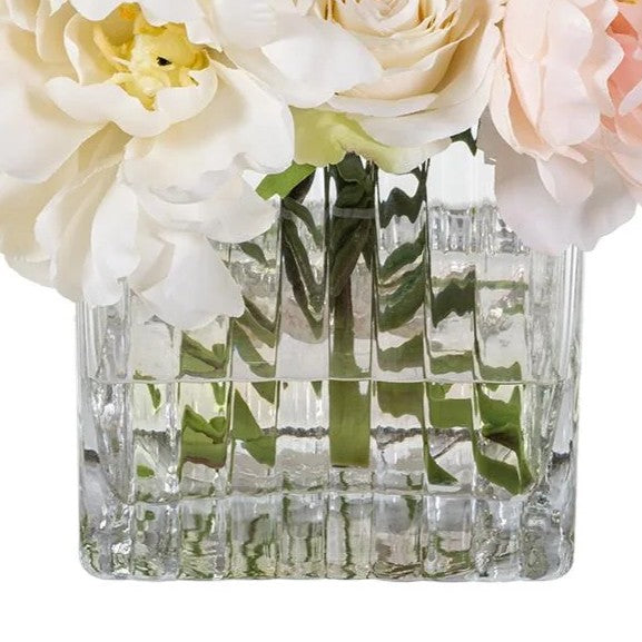 Close view of Rosalie’s visible green stems, acrylic faux water, and block-cut clear glass vessel.