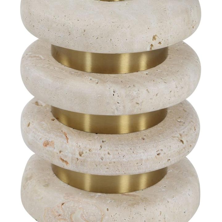 Close view of Rémi’s stacked travertine ring base separated by narrow brushed-brass-finished bands.