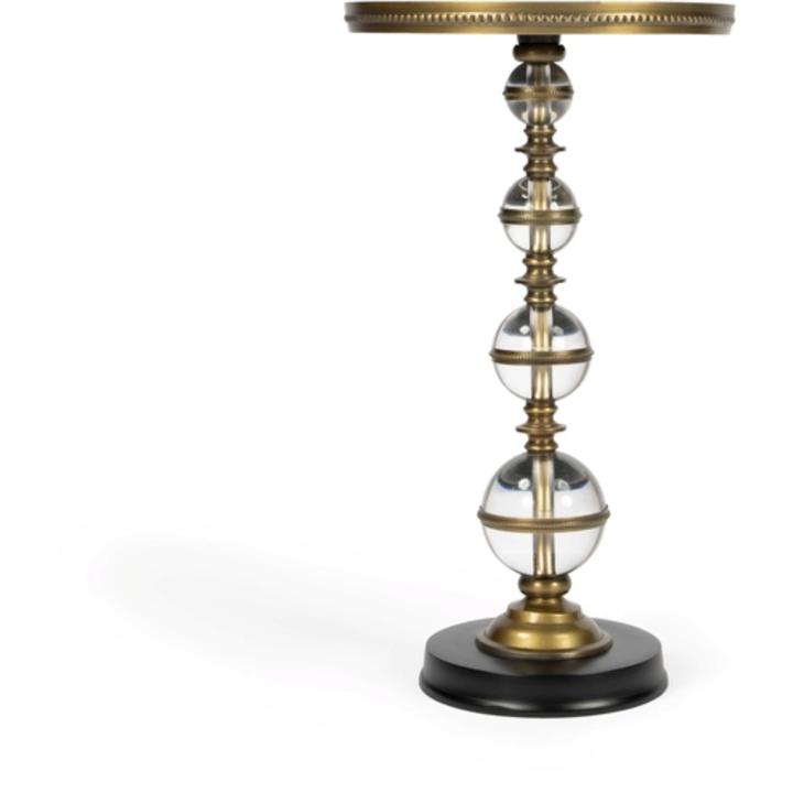 Close product view of the Béatrice Pedestal Side Table showing the transparent acrylic spheres and warm bronze-finished metal detailing.