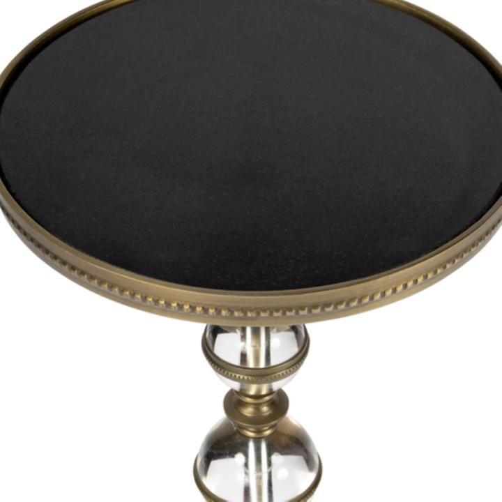 Product detail of the Béatrice Pedestal Side Table highlighting the clear acrylic spheres, bronze-finished collars, and dark round tabletop.