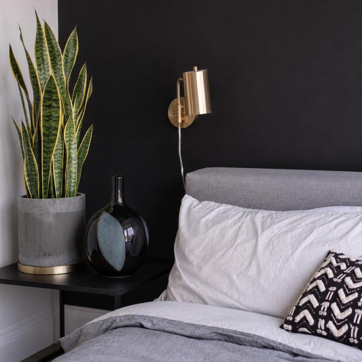 Additional product image of the black ceramic vase with steel-blue patinated patches.
