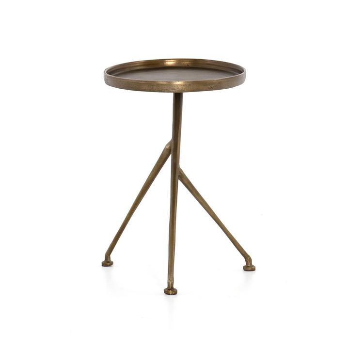 Detail of the Arlette Tripod Accent Table showing tonal highs and lows in the raw-brass finish over cast aluminum.