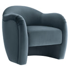 Storm-blue velvet barrel armchair with curved back and pleated arm detail, shown at a front angle