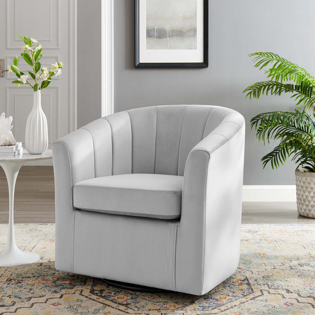 Ivory velvet swivel armchair styled beside a marble side table and potted plant