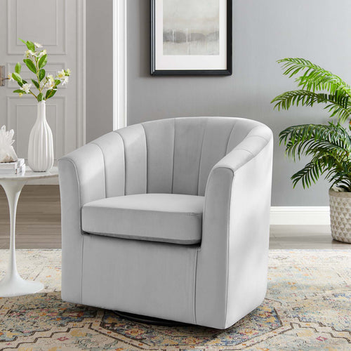 Ivory velvet swivel armchair styled beside a marble side table and potted plant