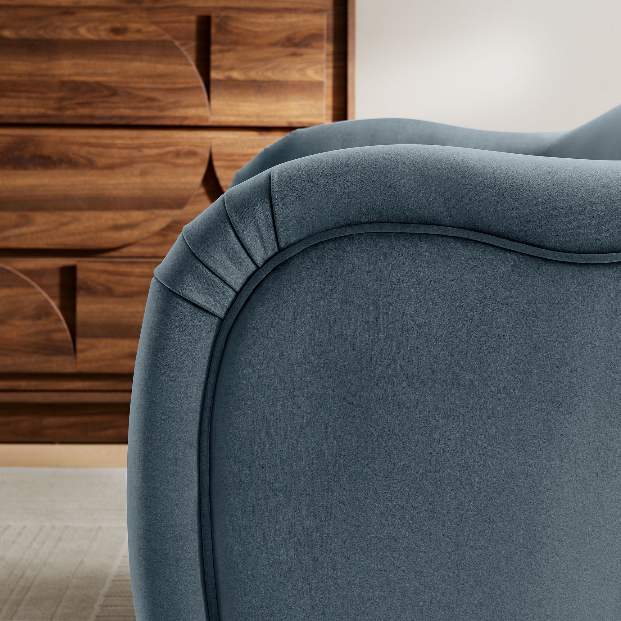 Close-up of French piping and hand-pleated fold detail on the arm of the Adeline Armchair
