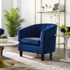 Storm-blue velvet curved armchair placed beside a marble-top side table in a modern living room