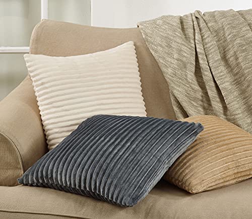 Three channel-ribbed faux fur throw pillows in charcoal, tan, and cream styled on a sofa