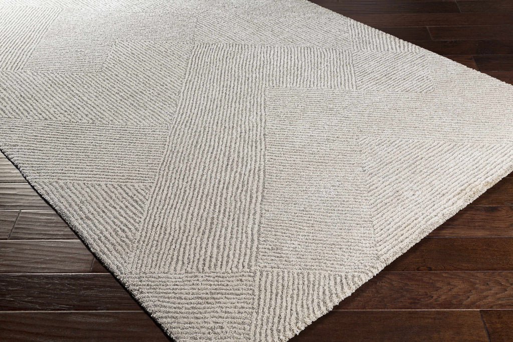 Rolled edge of Amandine rug revealing high pile face and woven backing construction