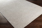 Rolled edge of Amandine rug revealing high pile face and woven backing construction