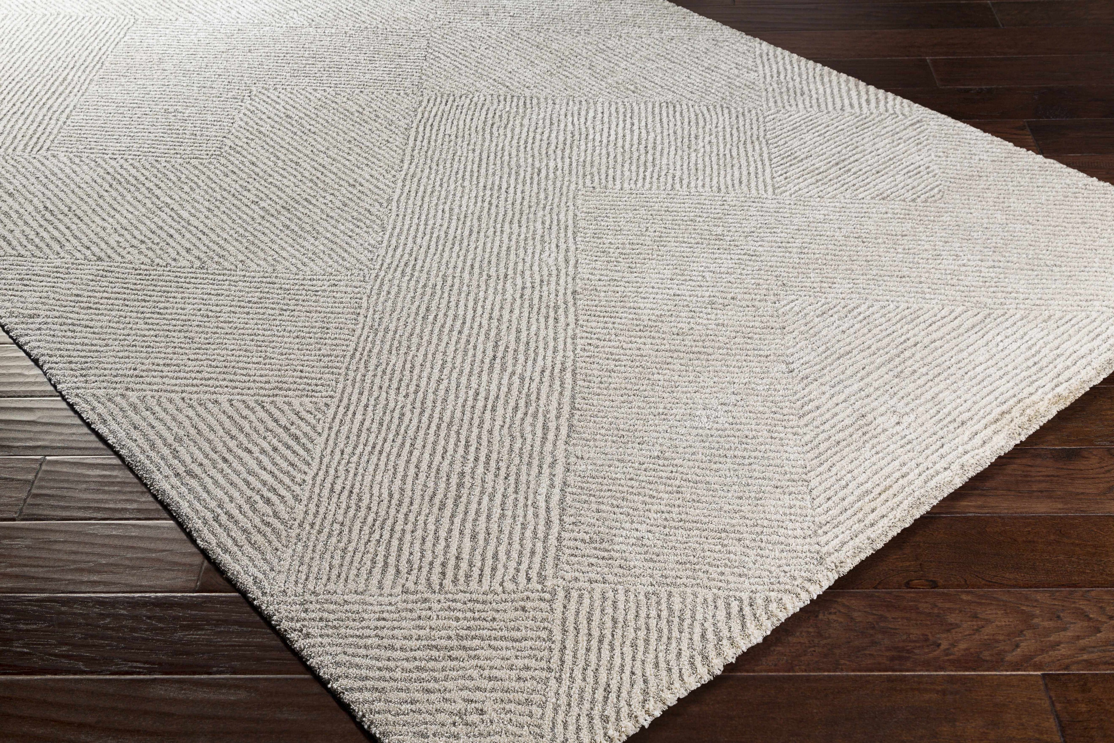 Rolled edge of Amandine rug revealing high pile face and woven backing construction