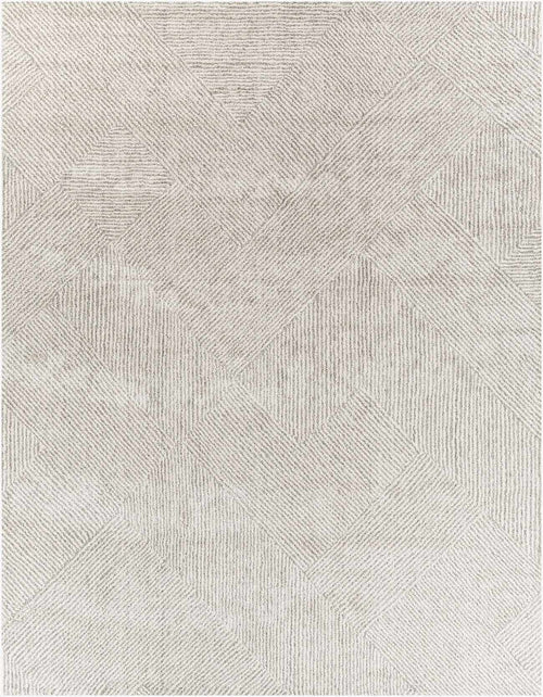 Close-up of tonal ivory and gray interlocking diamond weave pattern on high pile rug