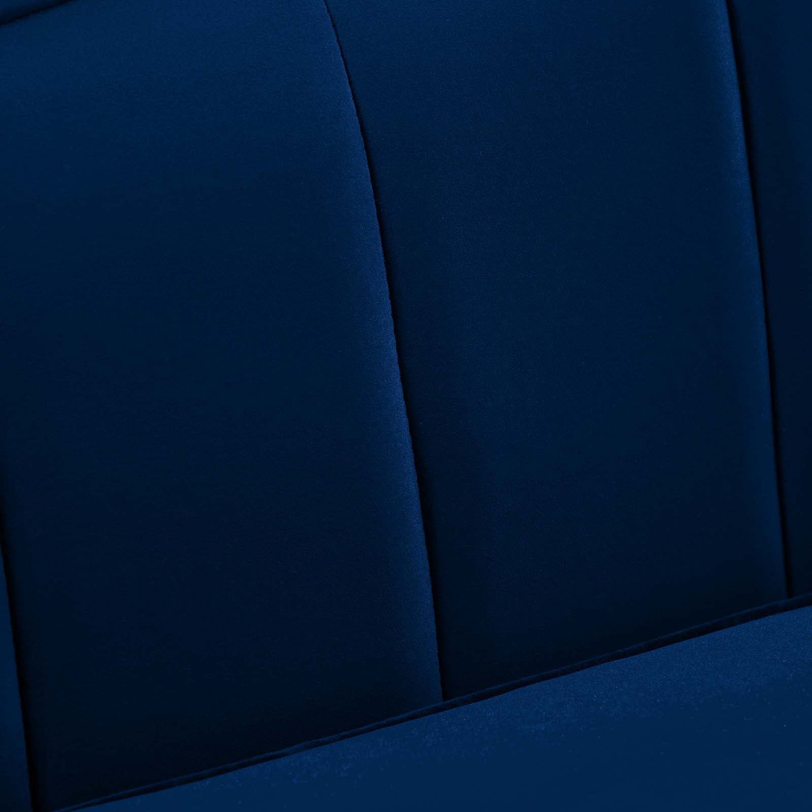 Macro detail of navy velvet channel tufting texture and stitched seams on the Bernadette Sofa's backrest