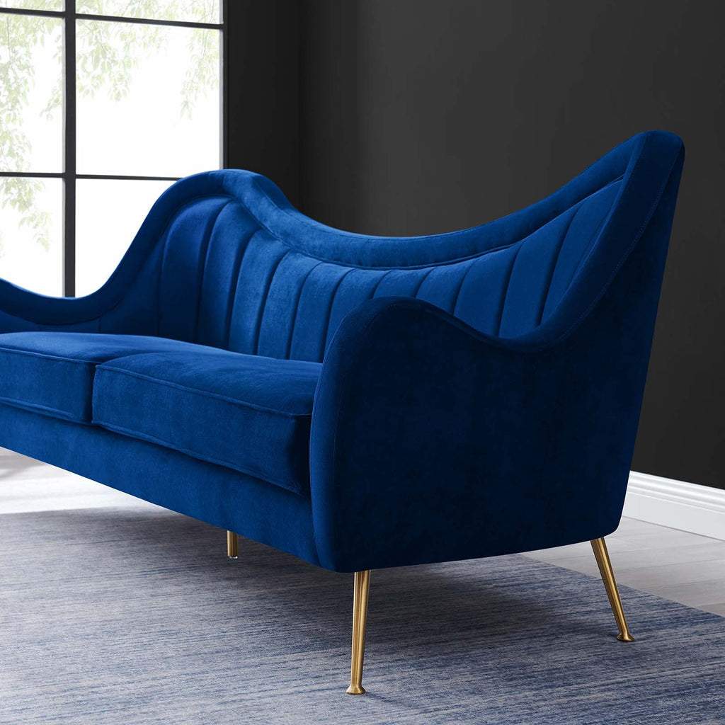 Close-up of Bernadette Sofa's scalloped high back and brushed gold tapered leg against a dark charcoal wall