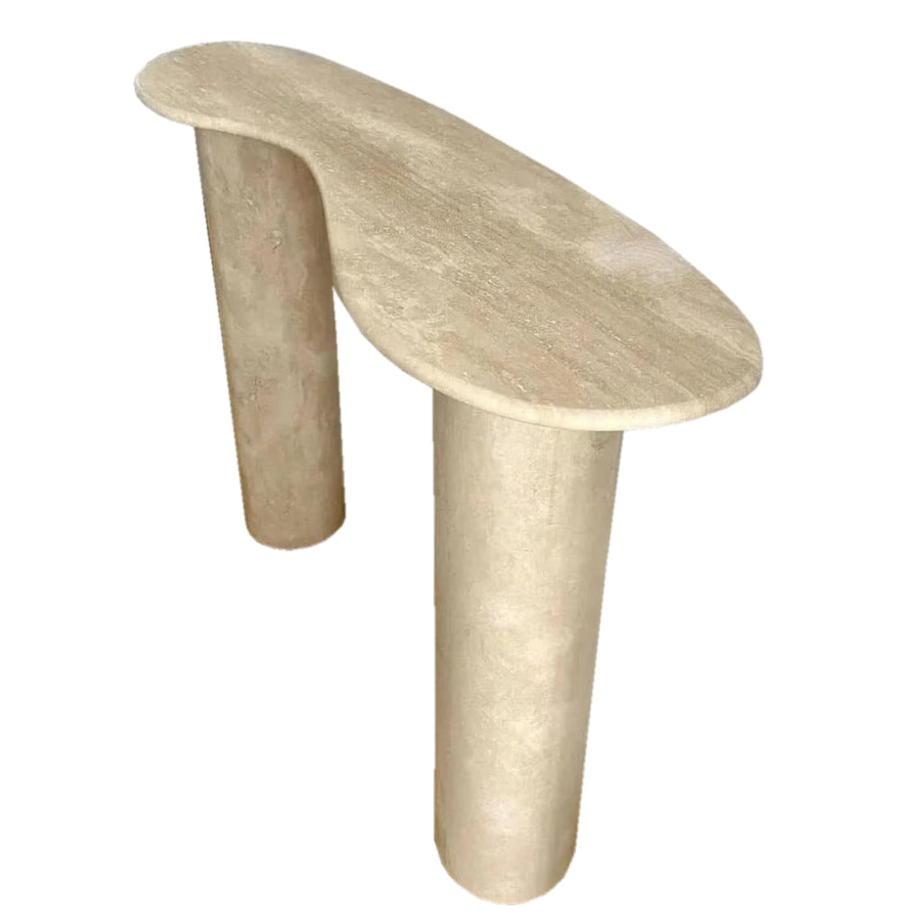 The Céleste Console in honed travertine, showing its organic curved top and two cylindrical column legs on a white background.