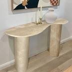 The Céleste Console in a living room setting, styled with candlesticks and a ceramic vase against a gallery wall.