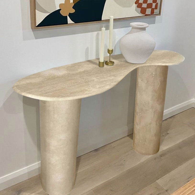 The Céleste Console in a living room setting, styled with candlesticks and a ceramic vase against a gallery wall.
