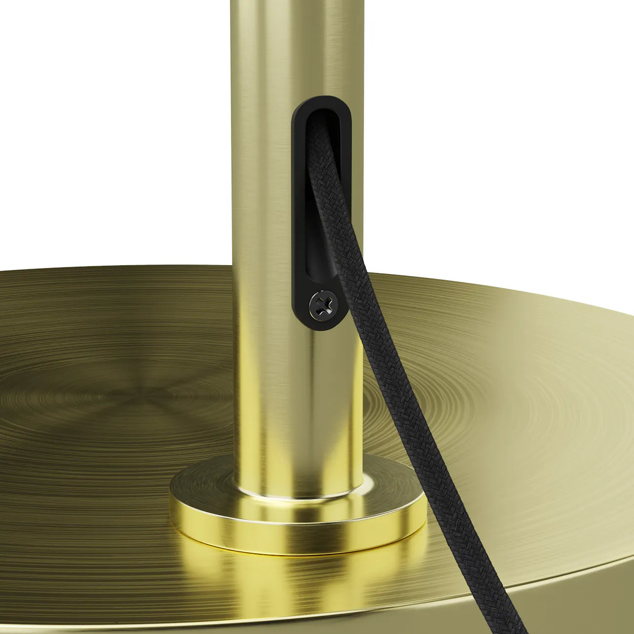 Close-up of the round brass base and cord channel on the Constance Floor Lamp