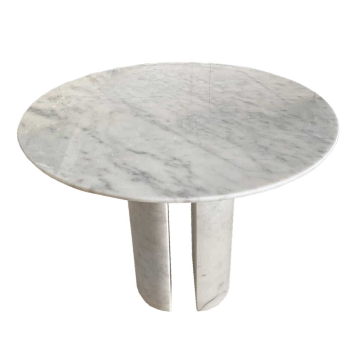 Corinne Dining Table, angled viewAngled view of round marble dining table showing twin curved marble legs and tabletop veining