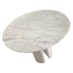 Close angled view of round marble tabletop and twin leg base showing natural veining