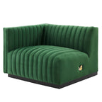 Clean three-quarter studio presentation of the Velvet Rogue emerald green velvet loveseat, highlighting the continuous vertical channel tufting and the hidden black plinth base against a white backdrop.