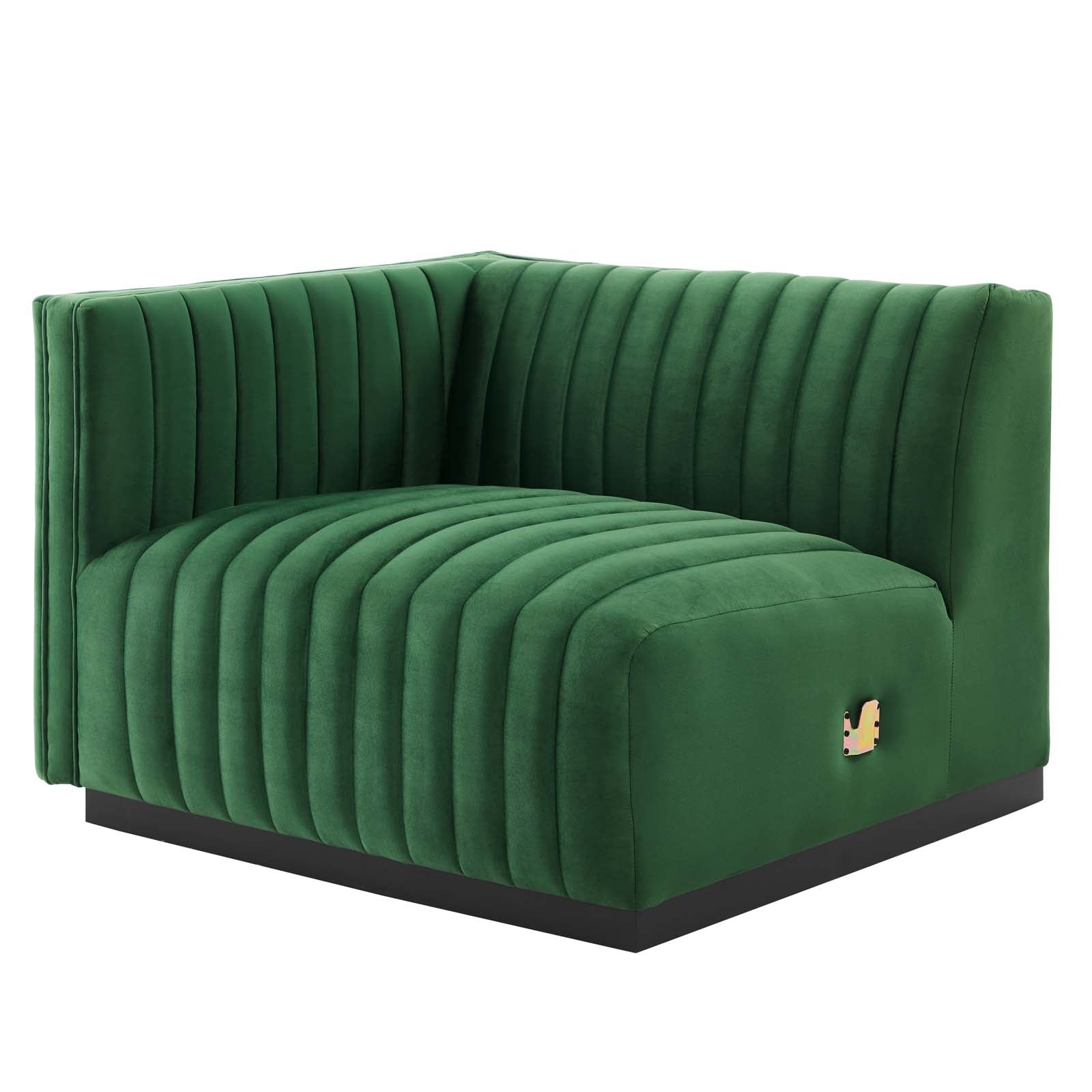 Clean three-quarter studio presentation of the Velvet Rogue emerald green velvet loveseat, highlighting the continuous vertical channel tufting and the hidden black plinth base against a white backdrop.