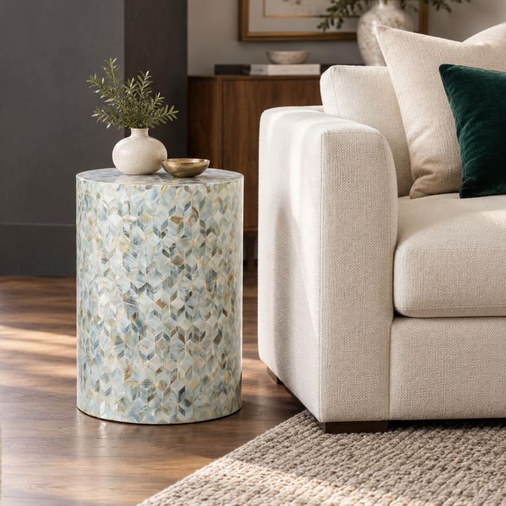 The Aurore Side Table styled in a refined contemporary interior, showing its realistic scale and material character in room context.