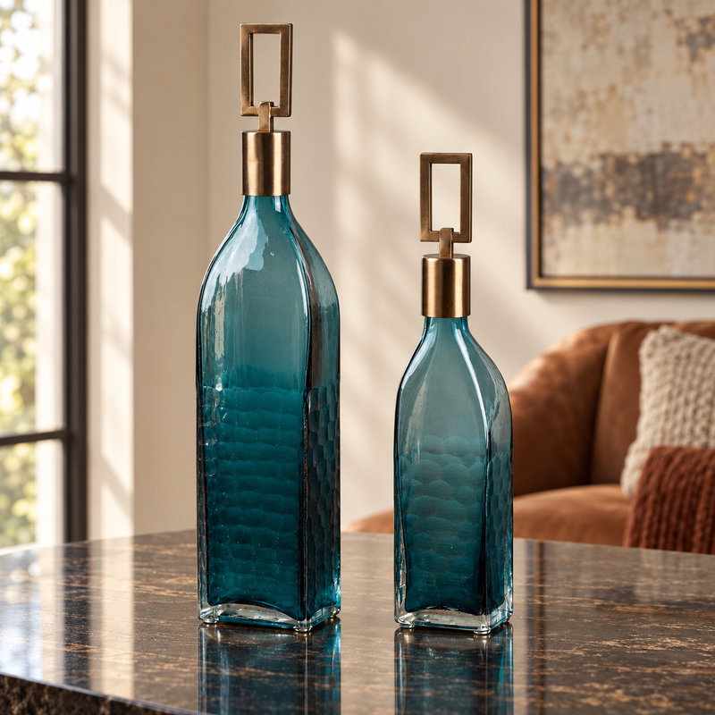 The Coralie Glass Bottle Set styled in a refined contemporary interior, showing its realistic scale and material character in room context.