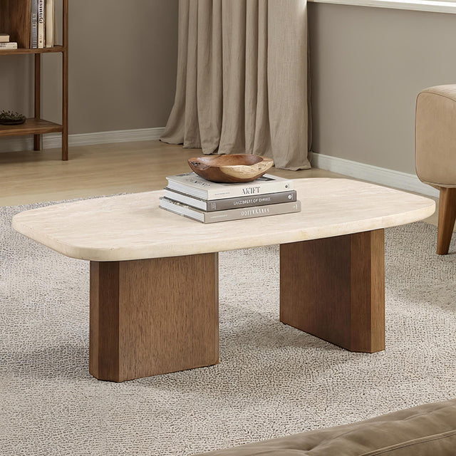 The Elodie Coffee Table in travertine and brown oak, styled in a living room and showing its organic oval silhouette.