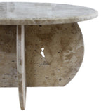 Close-up of the curved travertine base forms beneath the Héloïse Coffee Table's tabletop