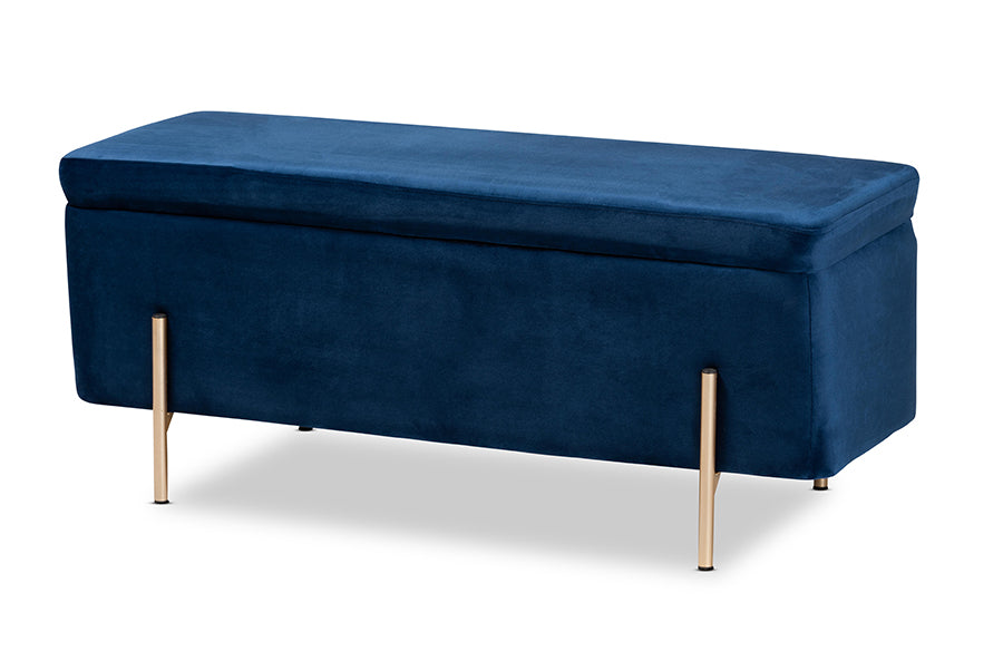 Navy blue velvet storage bench with closed lift-top cushion and slim brushed-gold legs, front three-quarter view