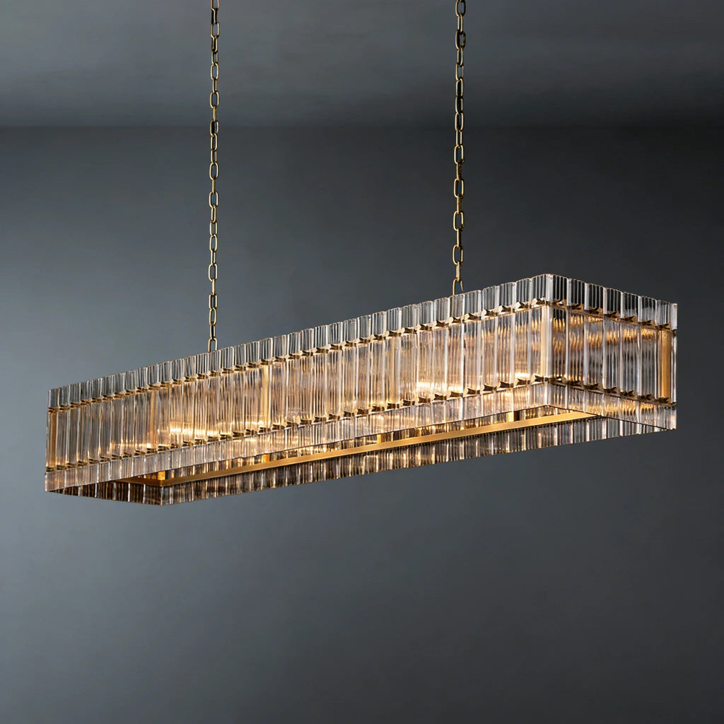 Rectangular glass rod chandelier lit from within, showing gold frame and hanging chain detail