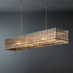 Rectangular glass rod chandelier lit from within, showing gold frame and hanging chain detail