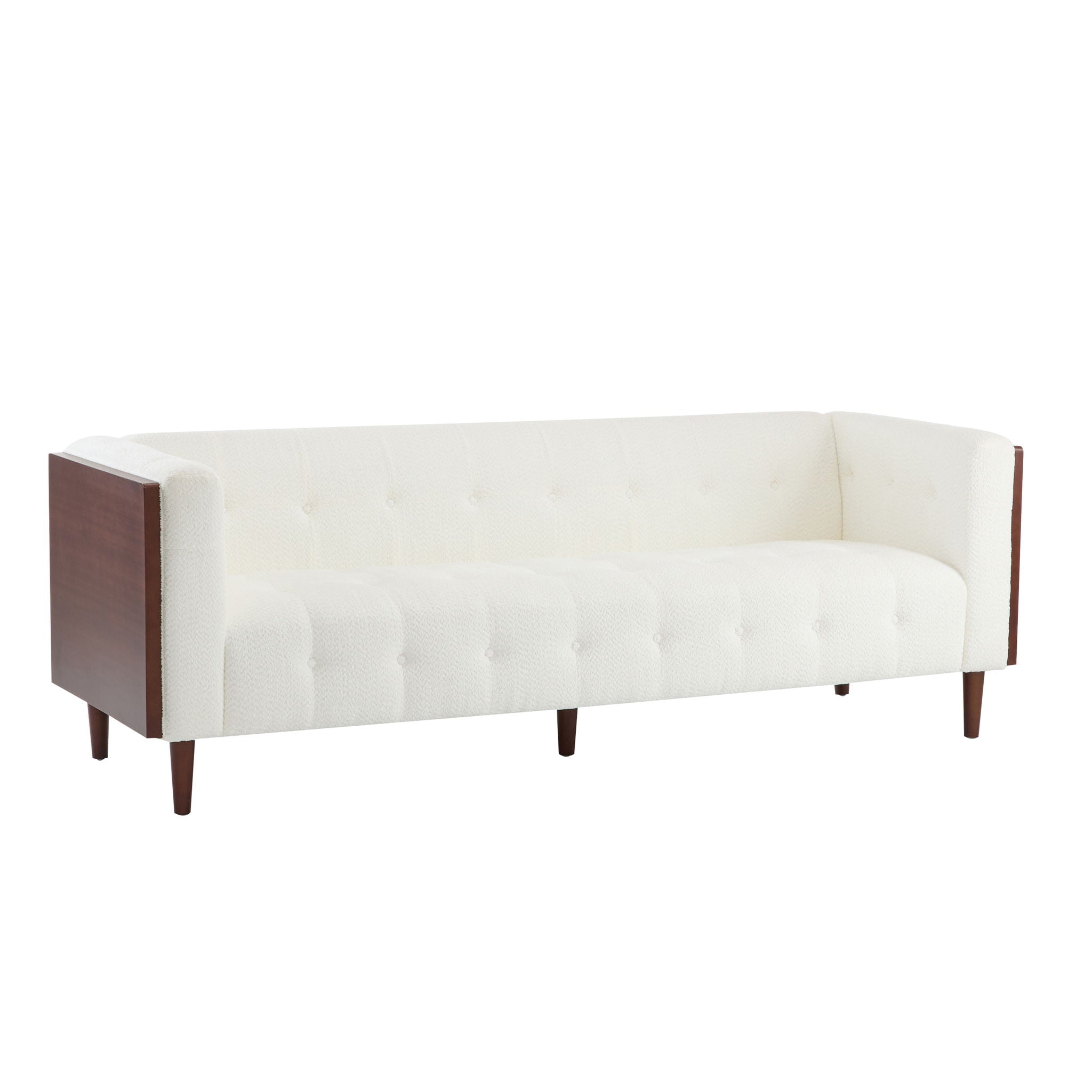 Minimalist 90-inch tuxedo sofa from the Monolith collection featuring a continuous, high-profile silhouette and subtle internal tufting in a textured cream bouclé fabric. Shown from a three-quarter studio view highlighting the dark wood arm casing against a white background.
