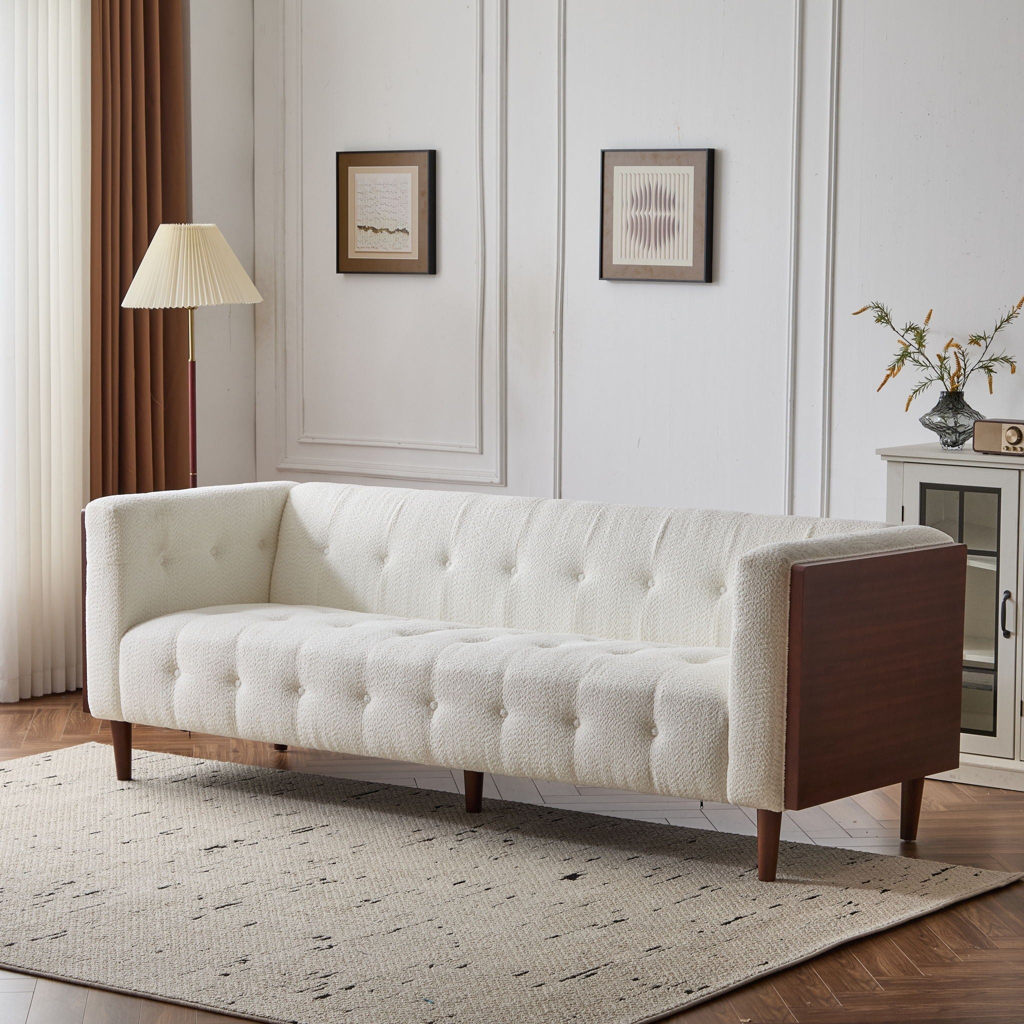 Minimalist 90-inch tuxedo sofa from the Monolith collection featuring a continuous, high-profile silhouette and subtle internal tufting in a textured cream bouclé fabric. Shown in a living room