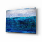 Horizontal blue and grey abstract seascape tempered glass wall art viewed at an angle