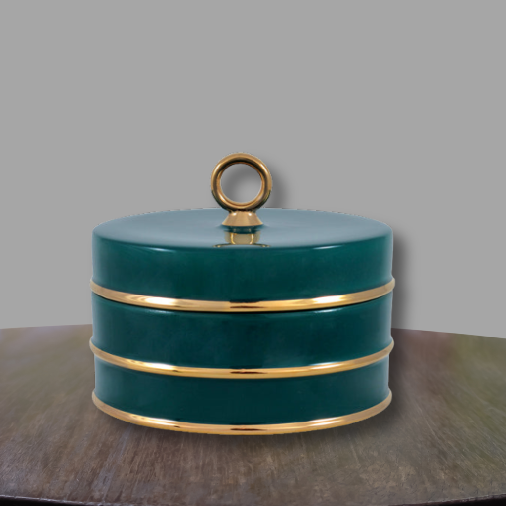 Peacock green and gold porcelain accent box displayed on a wood console against a neutral gray backdrop