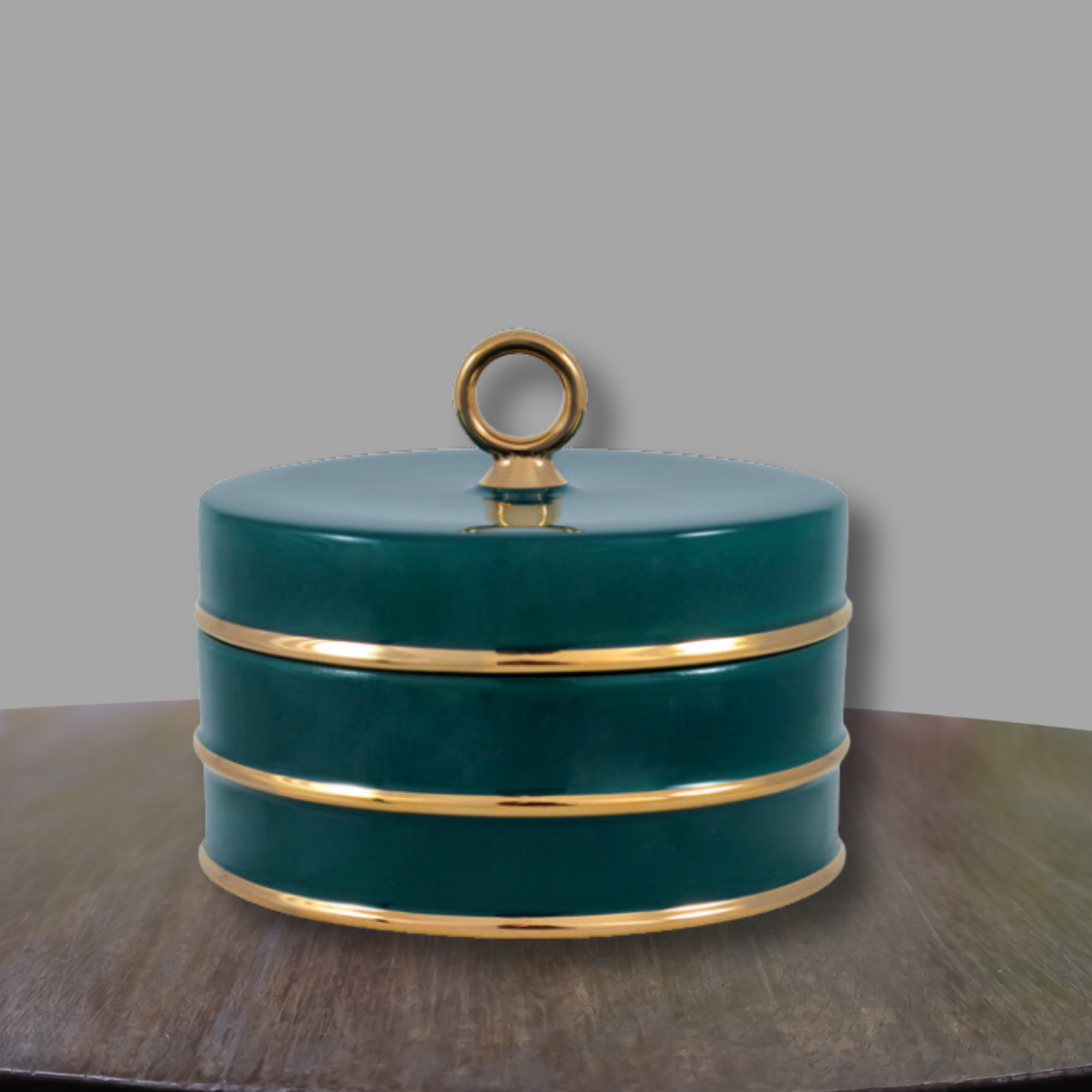 Peacock green and gold porcelain accent box displayed on a wood console against a neutral gray backdrop