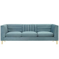 Light blue channel-tufted velvet sofa with brushed gold legs, shown straight-on